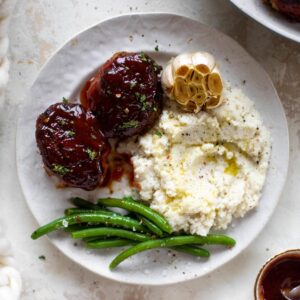 plate of Mini Turkey Meatloaf's with mashed potatoes and green beans.