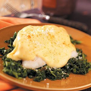 Baked fish over spinach with cheese sauce