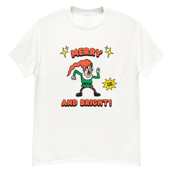 White T shirt with a retro-style elf character with a red hat, green suit, and black boots. The elf is striking a playful pose with a "Stay Good" speech bubble.