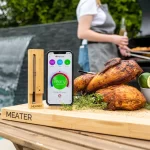 Meater pro probe thermometer next to smoked chicken