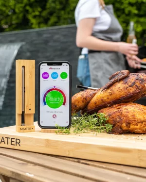 Meater pro probe thermometer next to smoked chicken