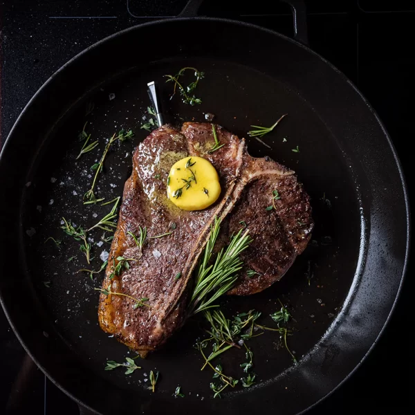 Meater pro probe thermometer in steak in cast iron skillet