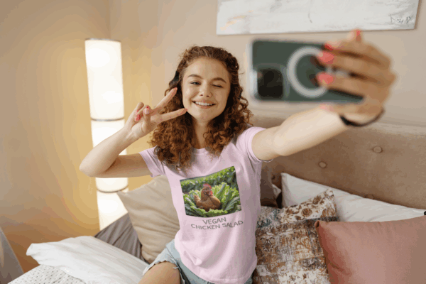 Woman wears pink vegan chicken salad t shirt